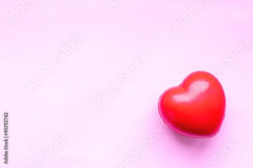 Fototapeta Naklejka Na Ścianę i Meble -  Valentines day red heart on pink paper background. Holidays card with copy space.
