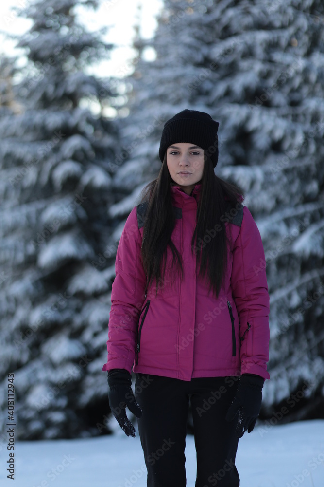Girl on winter snowy fir tree background on ski resort Girl on winter snowy fir tree background on ski resort