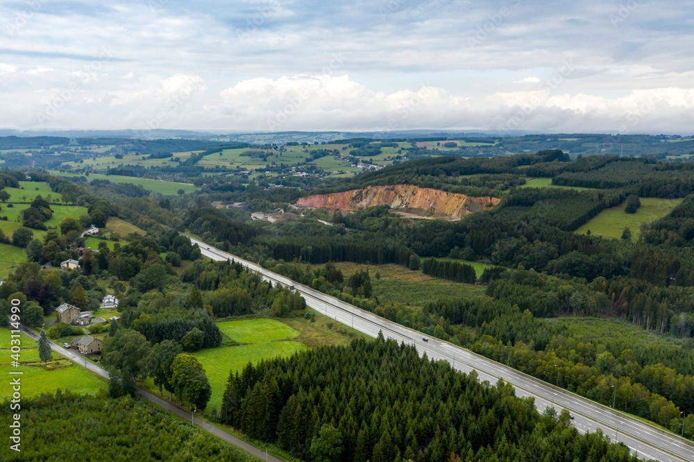Aerial view of a highway, in a hilly region, on a rainy day