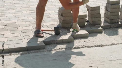 Worker laying paving slabs. We work with a rubber hammer. Close-up. Sound