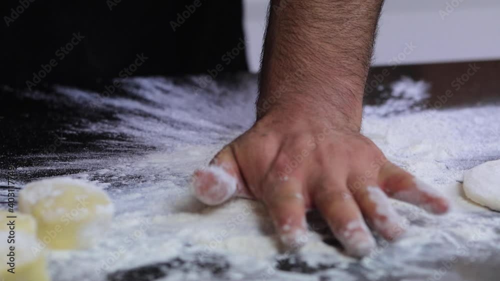An experienced chef in a professional kitchen prepares the dough , with flour. . High quality FullHD footage An experienced chef in a professional kitchen prepares the dough , with flour. . High quality FullHD footage