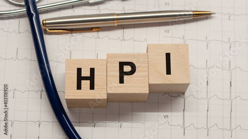 HPI word written on wooden blocks and stethoscope on light white background photo