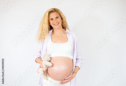 Young beautiful pregnant woman standing over white background. Free Download Young beautiful pregnant woman standing over white background. - GFXLoad