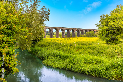 A view across a tributary to the Welland river of the Harringworth railway viaduct, the longest masonry viaduct in the UK photo