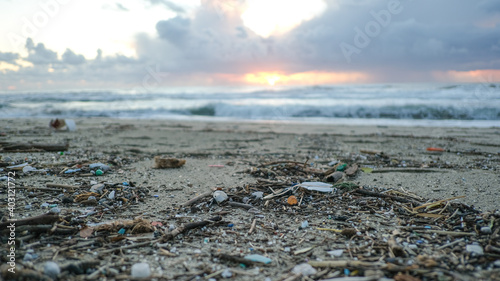Картината върху платно Micro plastics particles pollution on dirty sea coast,sunset time,environmental