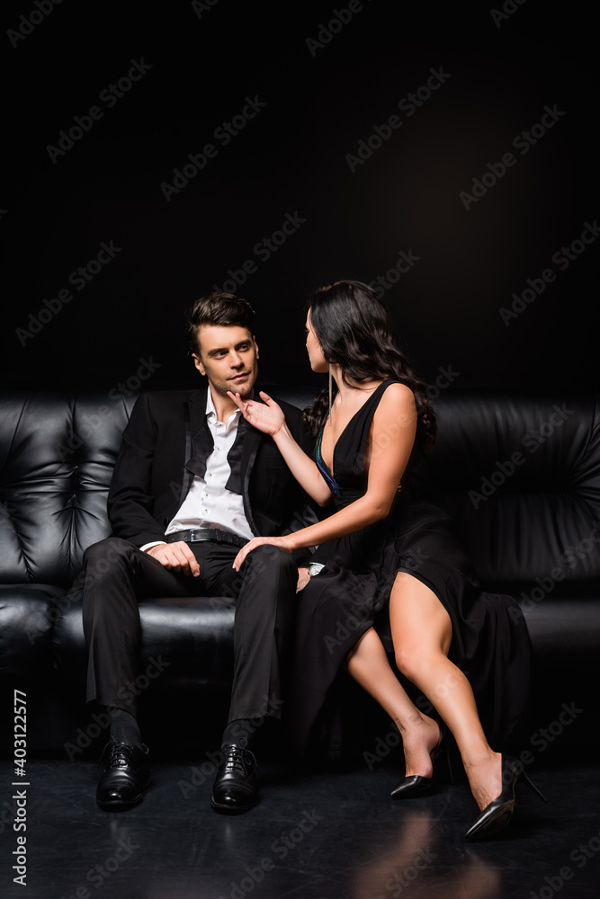 full length of elegant woman in dress seducing man in formal wear on black full length of elegant woman in dress seducing man in formal wear on black