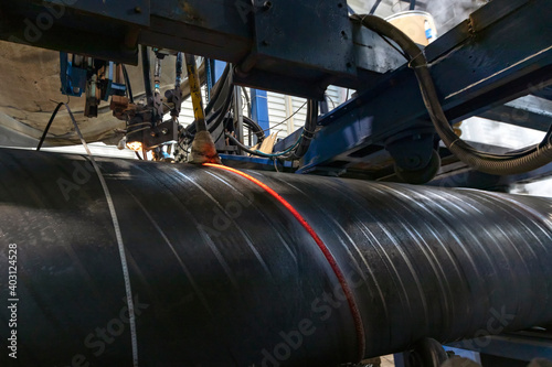 Obraz na plátně Automatic machine is welding to  spiral welded pipe