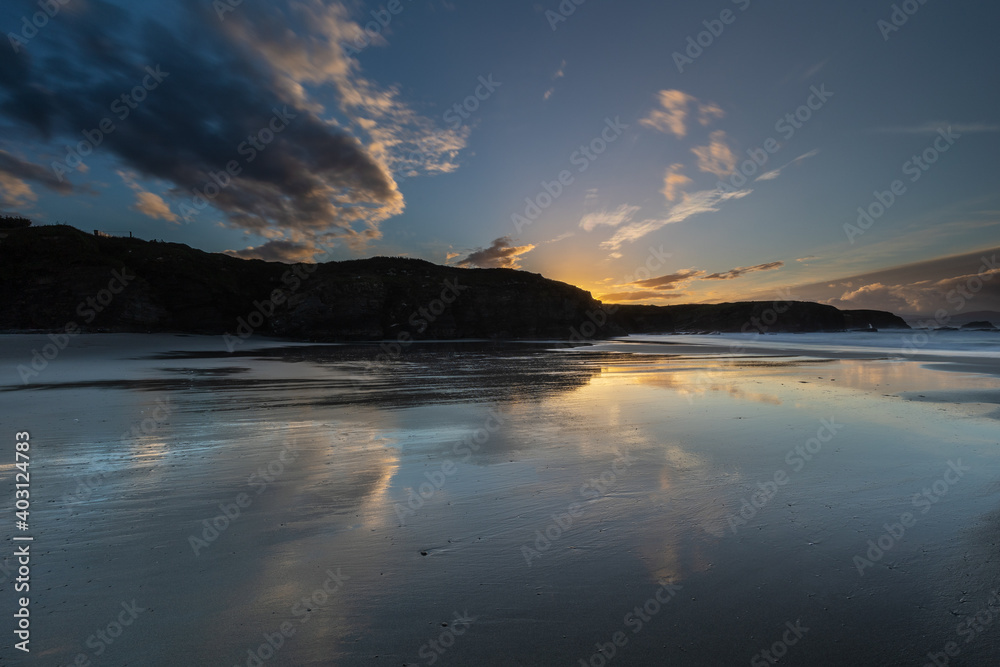 Winter sunset with reflections of clouds on the beach of Las Islas!
