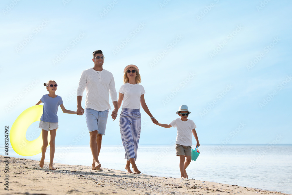 Happy family at beach on sunny summer day