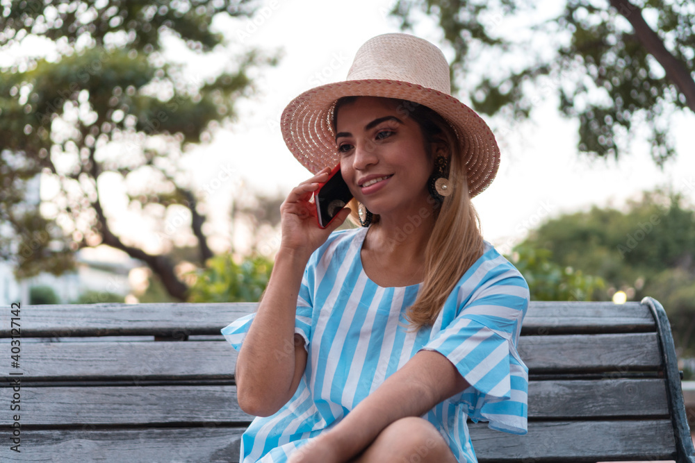 Fototapeta premium A woman talking on her cell phone