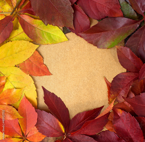 Abstract autumn fall frame with colorful leaves on vintage brown paper background.Flat lay  top view seasonal concept.