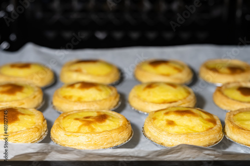 fresh made egg tarts in an oven © Freer