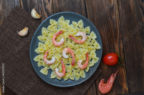 Pasta or spaghetti with shrimps, cherry tomatoes and garlic. Macaroni with seafood