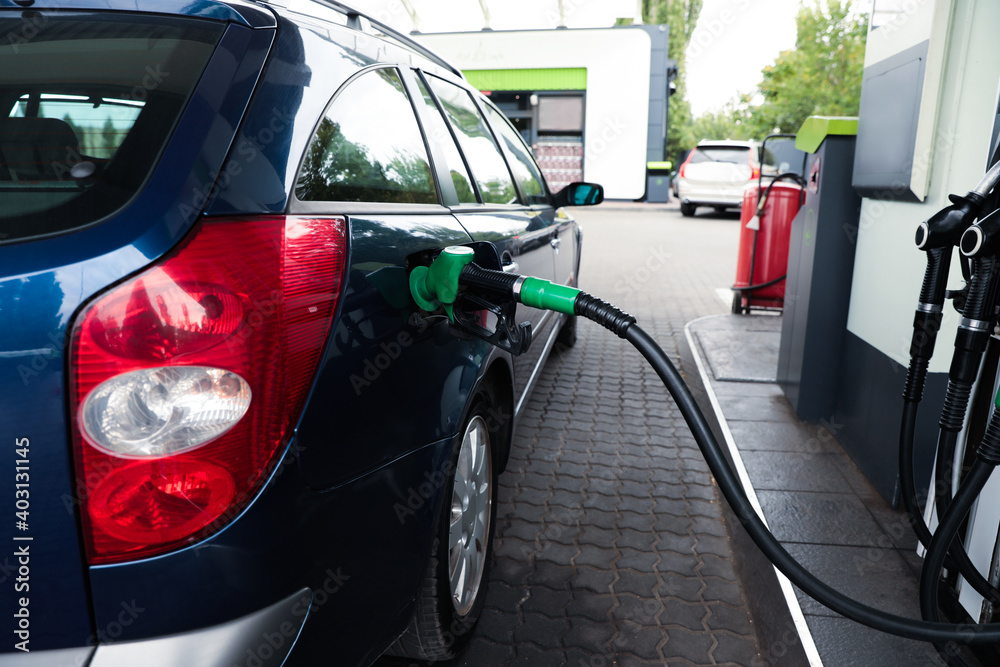 Refueling modern car at gas filling station, closeup