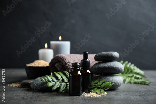 Spa composition with aroma oil on grey table photo