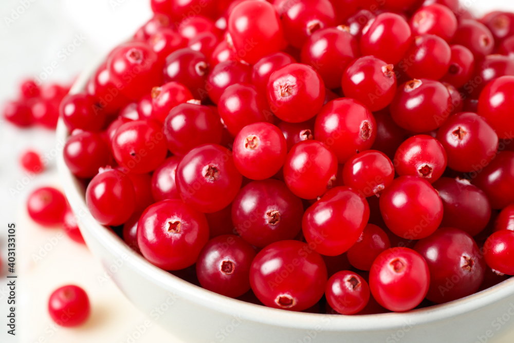 Bowl with tasty ripe cranberries on table, closeup Bowl with tasty ripe cranberries on table, closeup