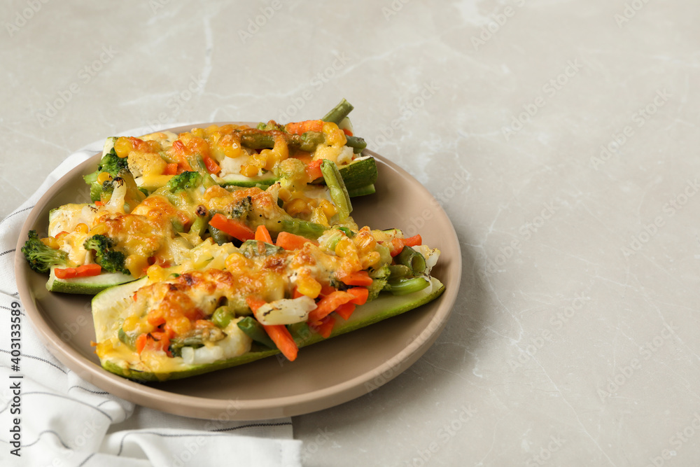 Baked stuffed zucchinis served on light grey table