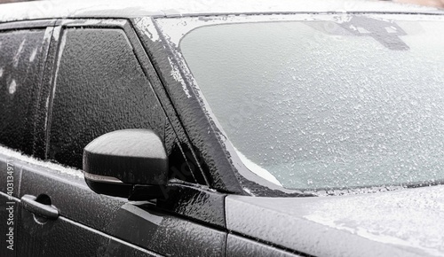 Icy car  ice scraping. Car in ice  winter.