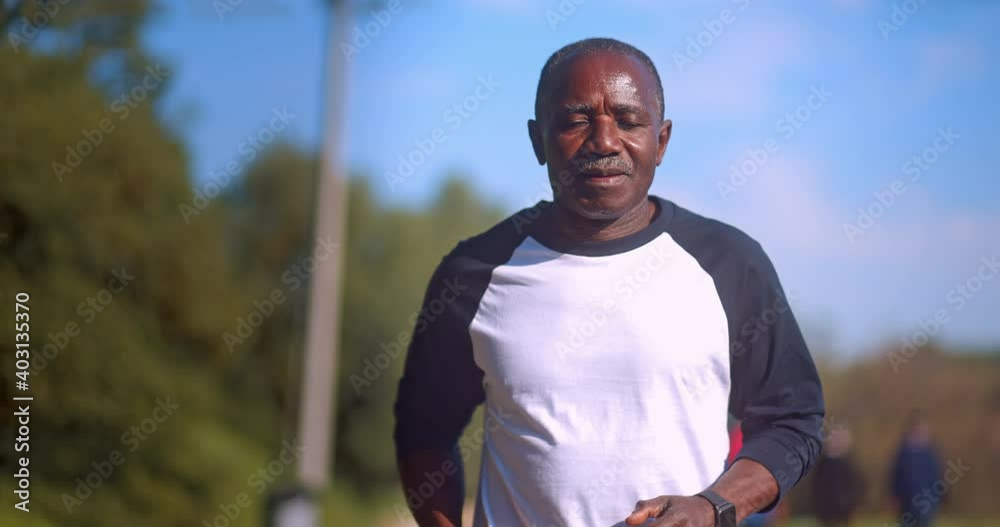 Senior african-american man jogging outdoors on park