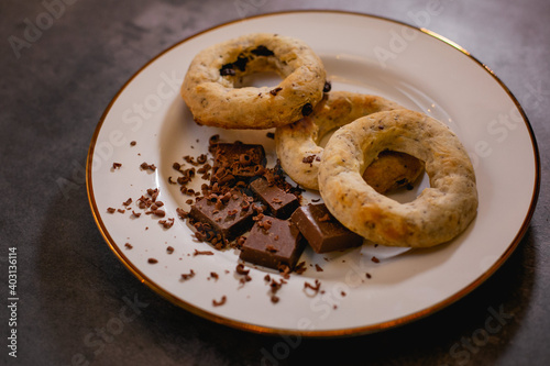 A white plate with gluten-free chocolate donuts and candy bars