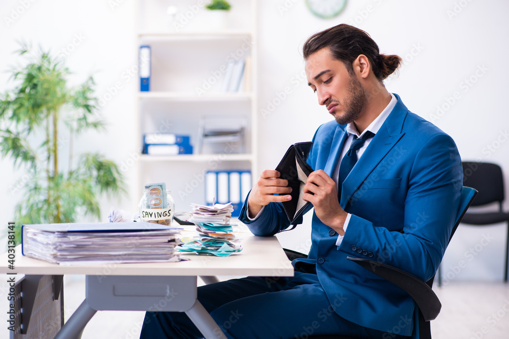 Young male accountant in budget planning concept Young male accountant in budget planning concept
