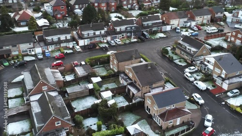 Snowy aerial village residential neighbourhood Winter frozen North West slow birdseye right over houses and roads