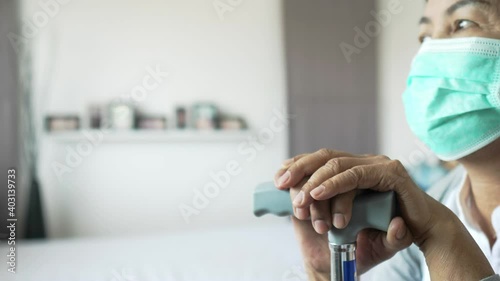 Wallpaper Mural Disabled elderly asian woman holding walking cane stick in hands,Depressed senior women stay at home during coronavirus and covid-19 epidemic or pandemic Torontodigital.ca