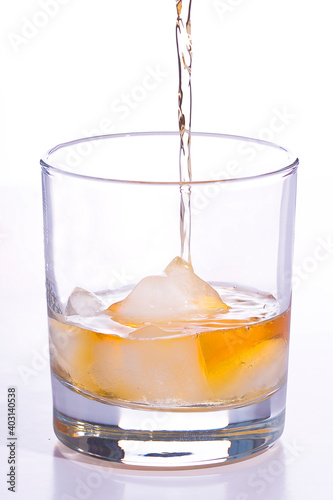 Whiskey poured into a glass