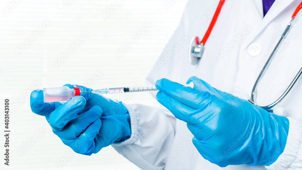 Doctors or scientists are carrying syringes with liquid vaccines for young and old to. prevent COVID-19 in the laboratory. Concept COVID-19 vaccine. Doctors or scientists are carrying syringes with liquid vaccines for young and old to. prevent COVID-19 in the laboratory. Concept COVID-19 vaccine.