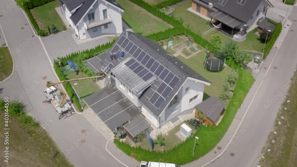 Aerial Over Workers Installing Solar Panels On Roof Of House With Crane. Top Down View Aerial Over Workers Installing Solar Panels On Roof Of House With Crane. Top Down View