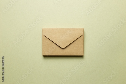 Kraft brown paper envelope on khaki background. top view, copy space