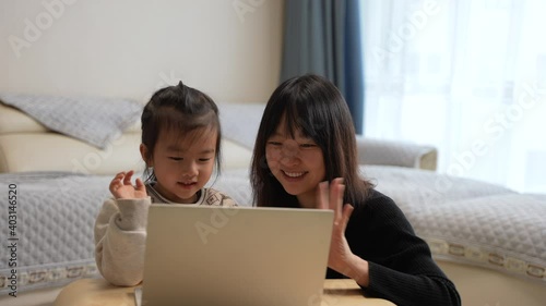 mother and daughter waving hands 