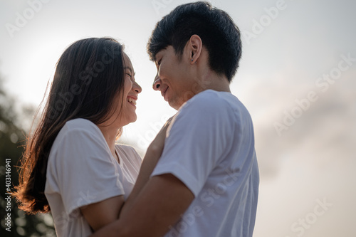 Young couple hugging and laughing on the beach. Couple on a summer vacation at the beach.Summer in love,Valentine day concept. © Day Of Victory Stu.