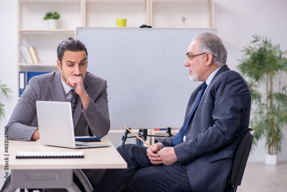Old and young businessmen in business meeting concept Old and young businessmen in business meeting concept