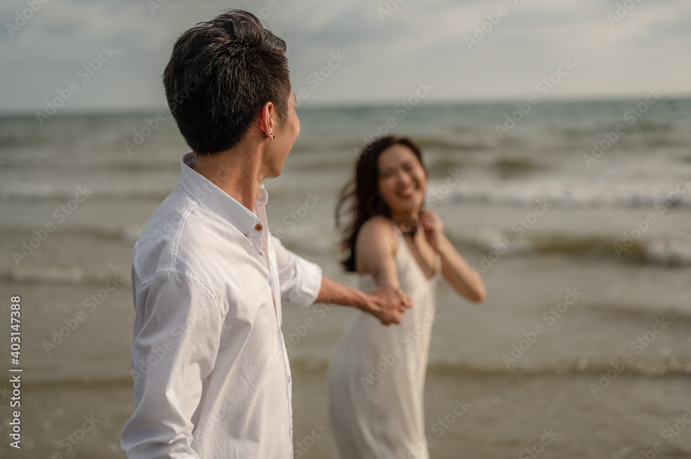 Beach vacation romantic walk couple relaxing on ocean summer travel destination.Young couples are having fun on the beach.Summer in love,Valentine day concept.