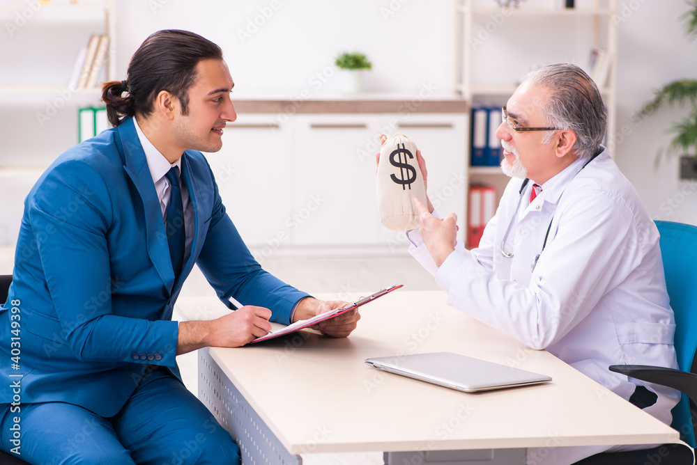Young businessman meeting with old doctor Young businessman meeting with old doctor