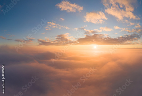 Sunrise panorama in orange and yellow colors. Sky background. View from an airplane during a vacation flight