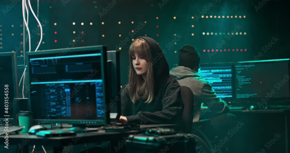 Group of hackers break into the banking system and steal customer data. They are happy with the success and give them a high five. Screemers work in a secret hideout in the center of a large city. Group of hackers break into the banking system and steal customer data. They are happy with the success and give them a high five. Screemers work in a secret hideout in the center of a large city.