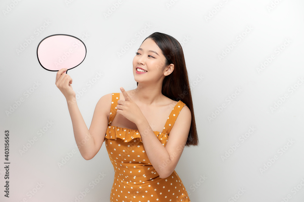 Attractive asian female with empty message box isolated on white background. Attractive asian female with empty message box isolated on white background.