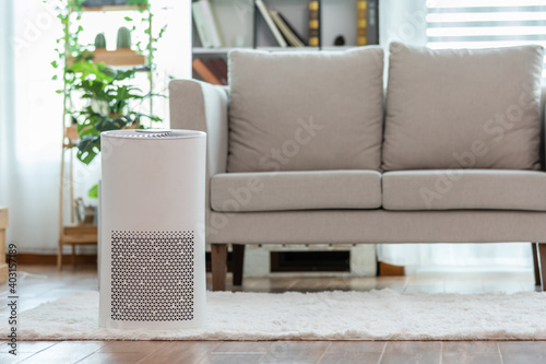 Air purifier in cozy white Living room for filter and cleaning removing dust PM2.5 HEPA in home,for fresh air and healthy life,Air Pollution Concept