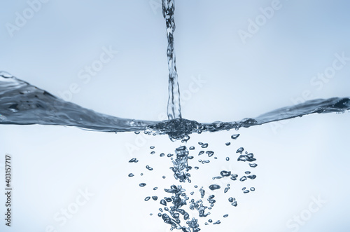 Water splash Aqua flowing in waves and creating bubbles Drops on the water surface feel fresh and clean.