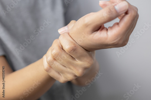 Woman suffering from pain in wrist.