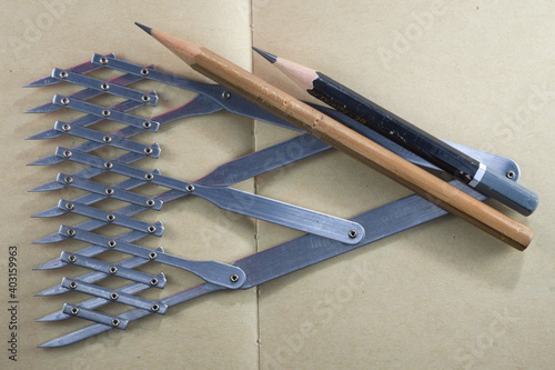 Divider and pencils on brown paper background