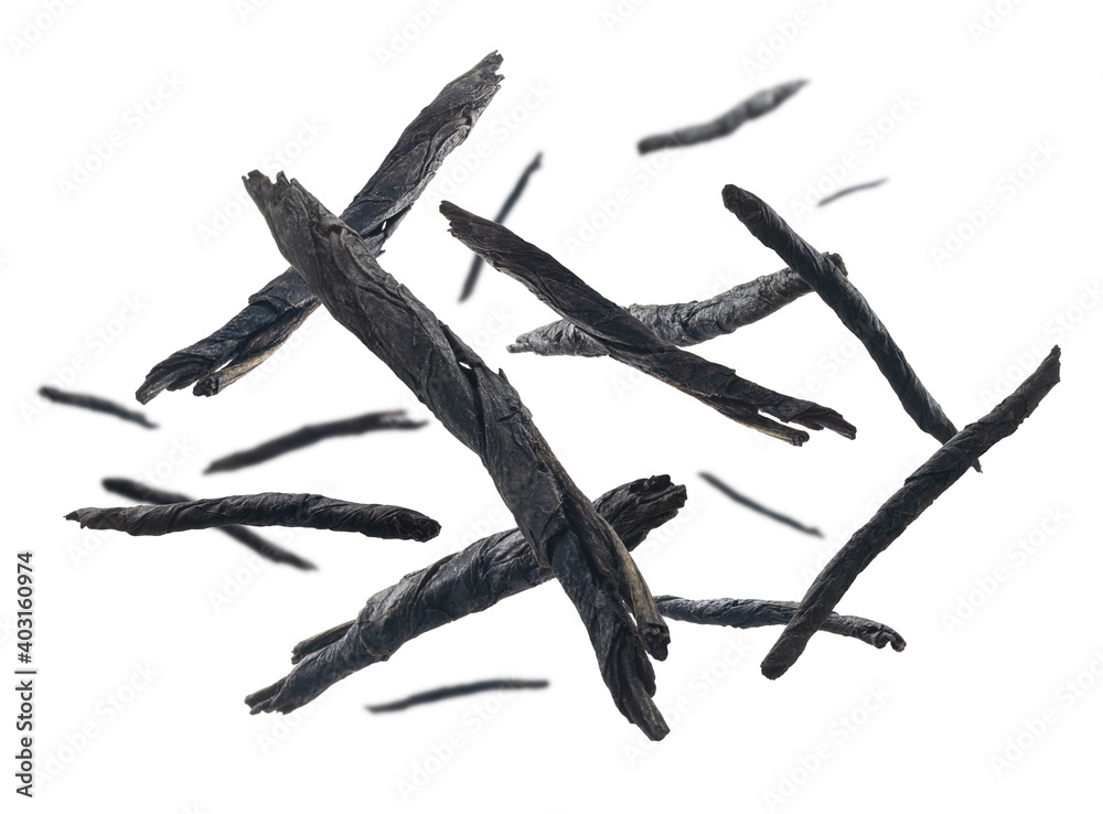 Obraz premium Dry twisted leaves of Kuding tea levitate on a white background