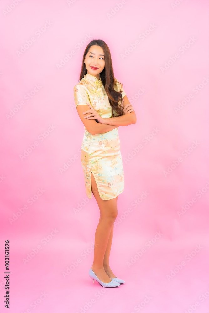 Portrait beautiful young asian woman smile in action with chinese new year concept Portrait beautiful young asian woman smile in action with chinese new year concept