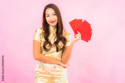 Portrait beautiful young asian woman with red envelopes in chinese new year concept