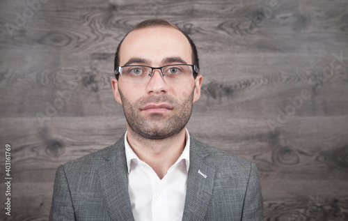 Caucasian young businessman wearing eyeglasses.