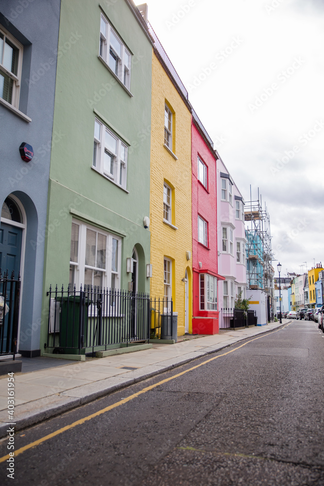 Row of colorful British houses with handrails and plants
