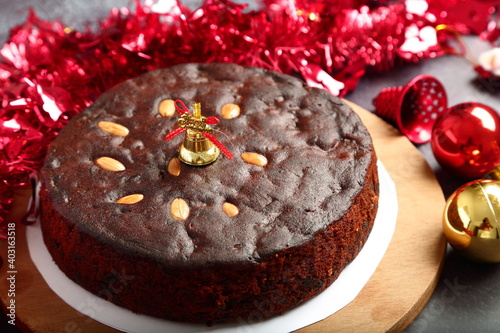 Photos Homemade Christmas dark plum cake  on a holidays background.