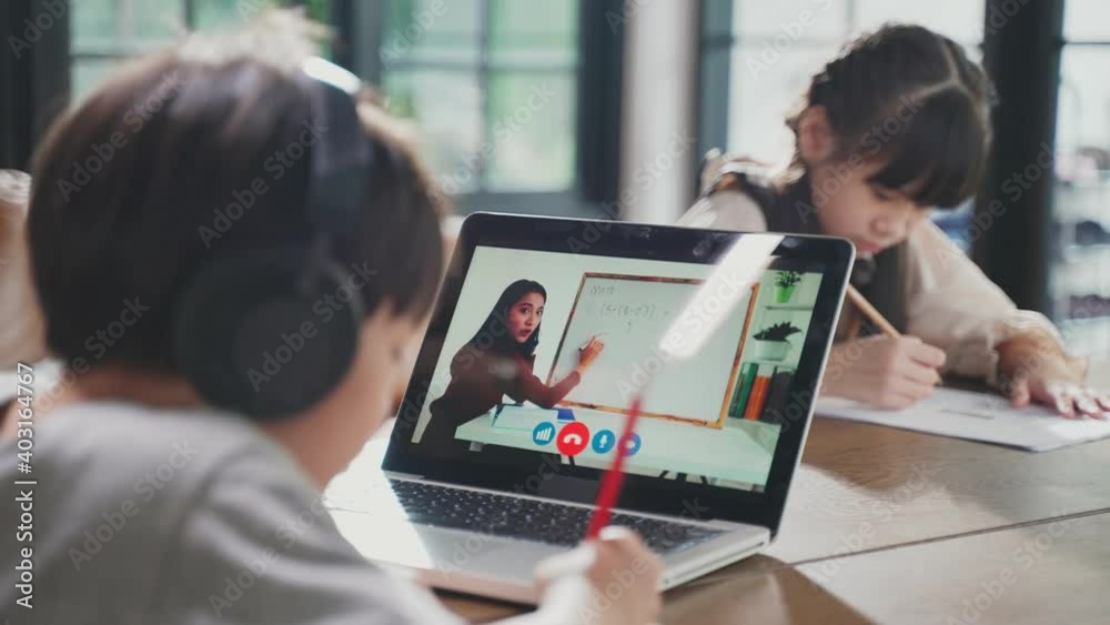 Homeschool Asian little young boy learning online class with teacher